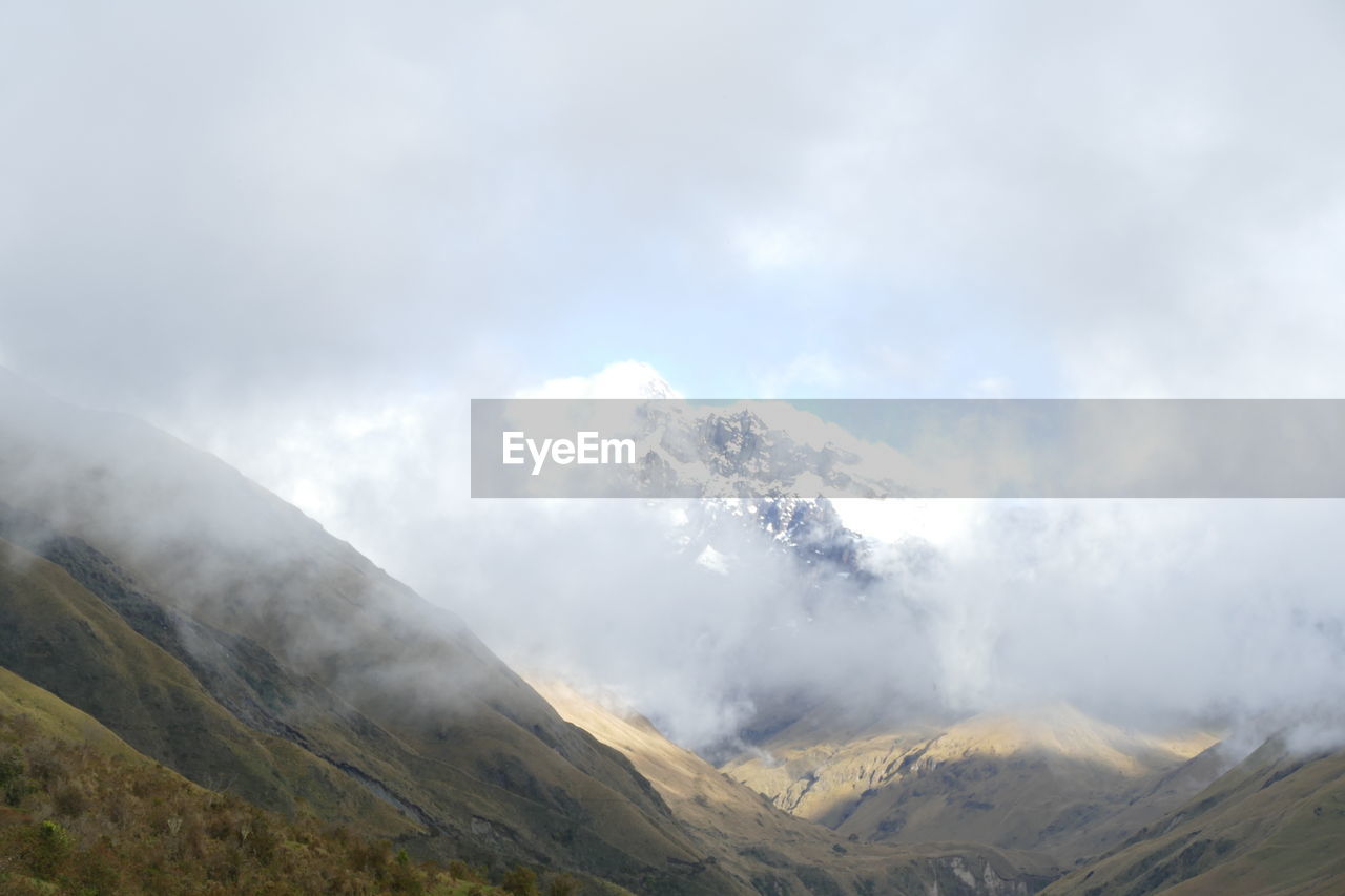 Scenic view of foggy mountain range