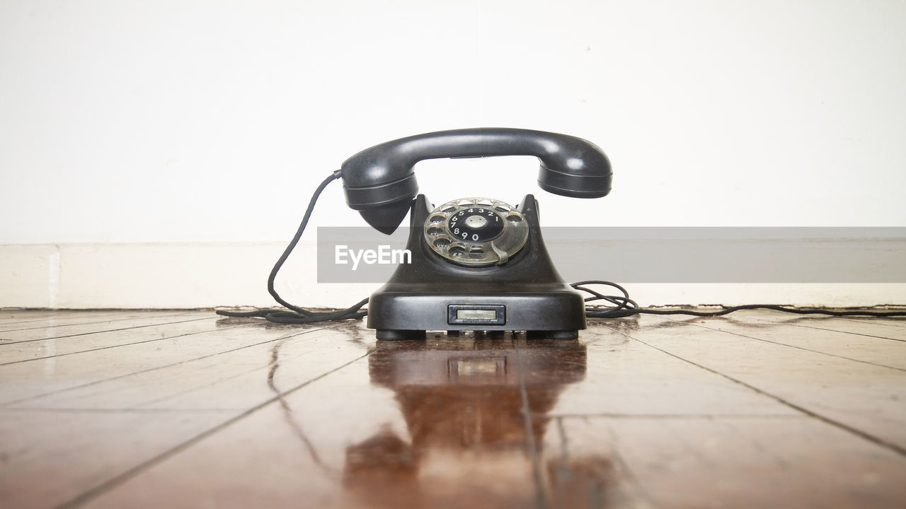 CLOSE-UP OF TELEPHONE BOOTH ON TABLE