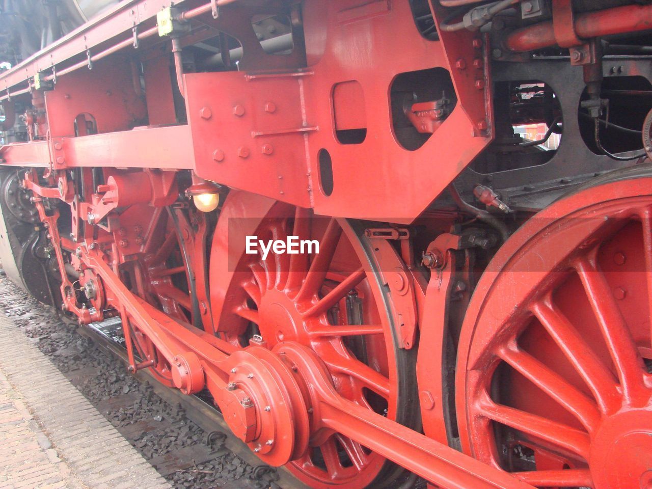 CLOSE-UP OF RED TRAIN ON RAILROAD TRACKS