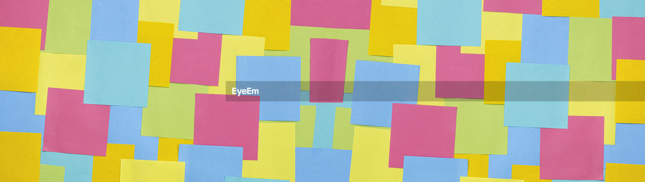 Multicolored sticky paper notes texture background, full frame