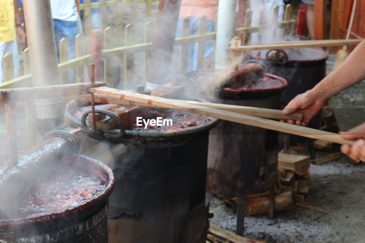 Cooking plum jam in big pots