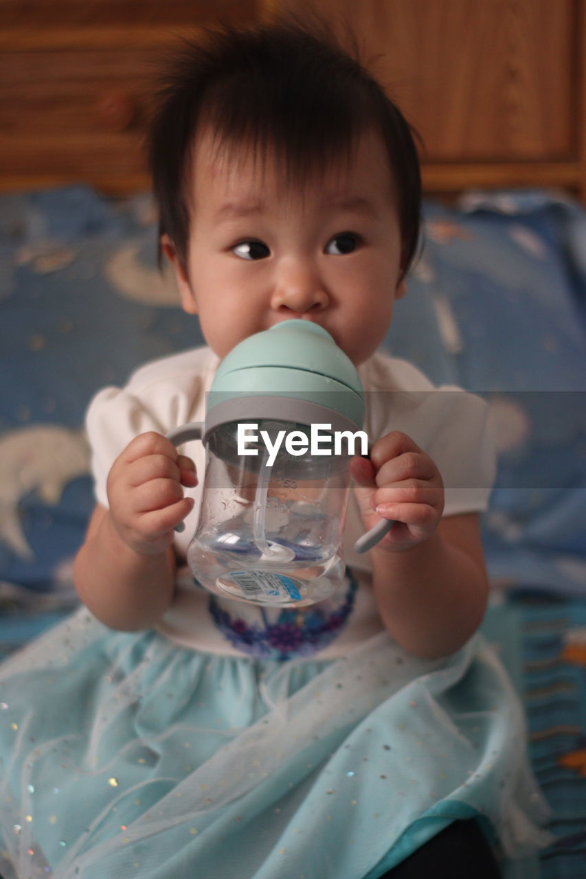 Close-up of boy drinking water