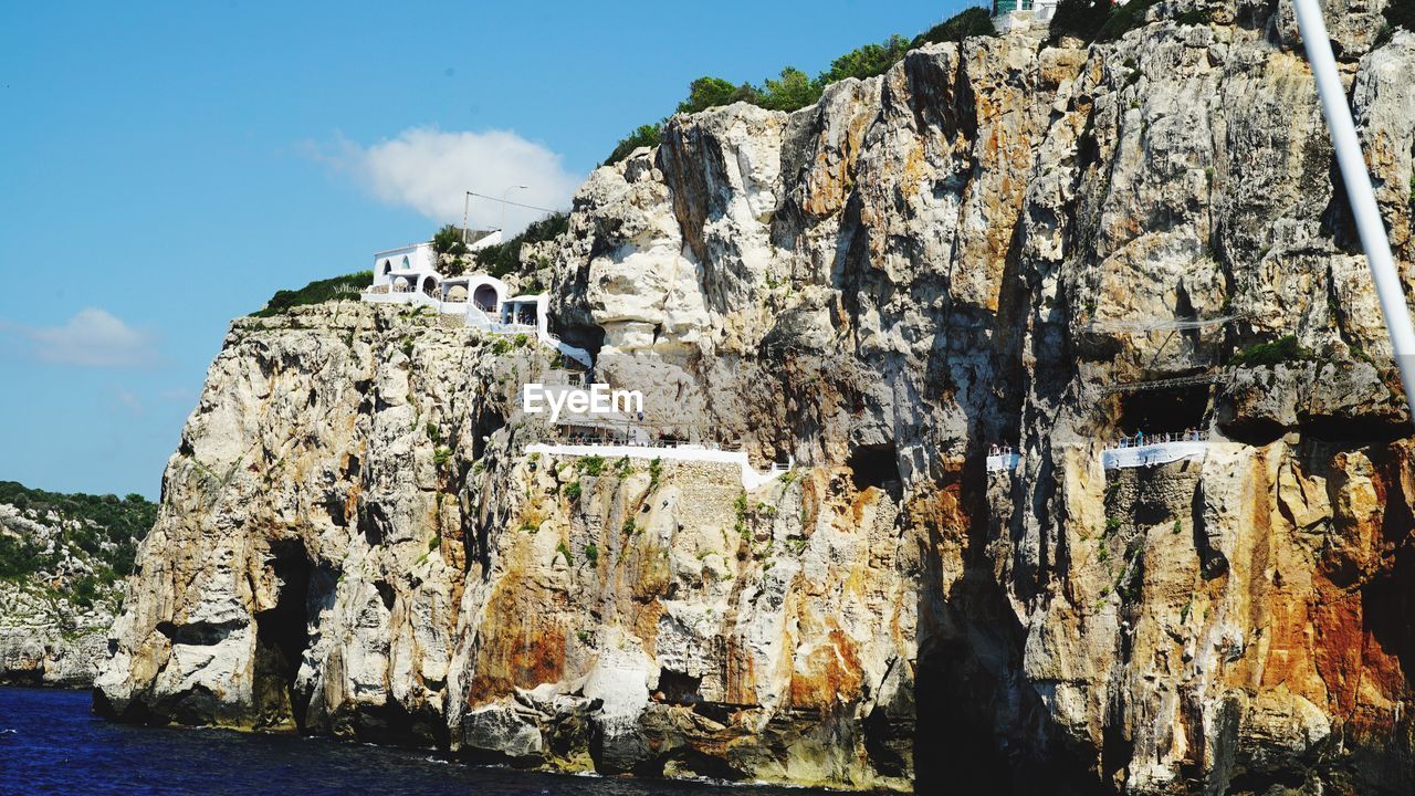 Rock formation against sky on sunny day