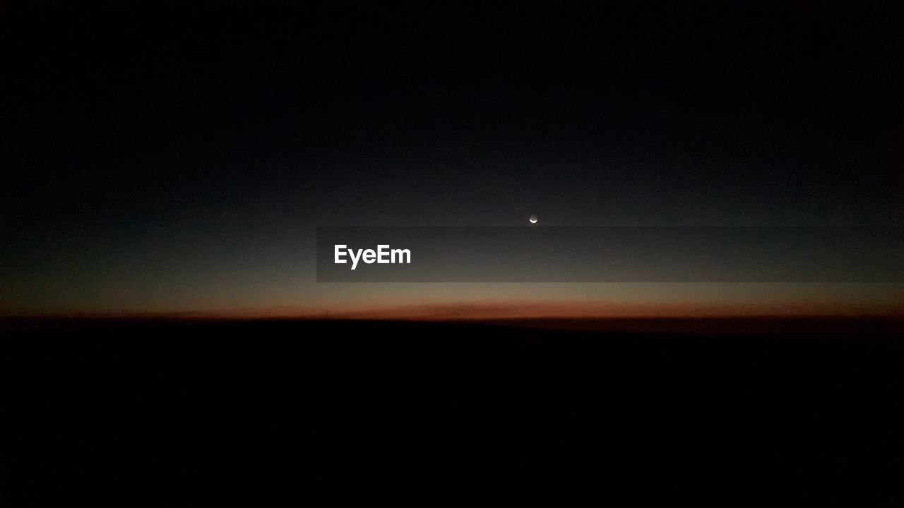 SCENIC VIEW OF SILHOUETTE LANDSCAPE AGAINST SKY AT NIGHT