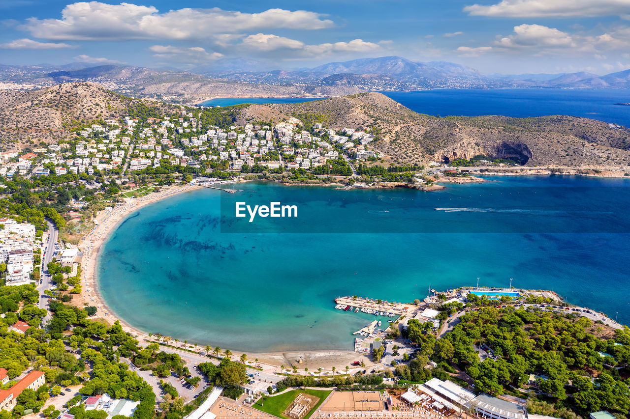 High angle view of residential district and sea against sky