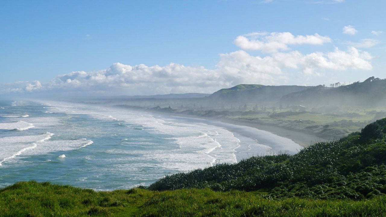 Scenic view of misty beach against sky