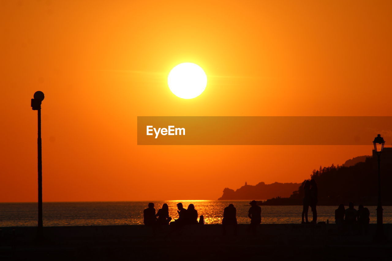 SILHOUETTE PEOPLE ON BEACH DURING SUNSET