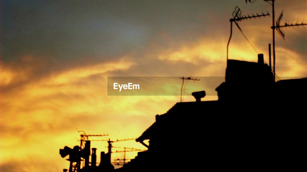 SILHOUETTE OF BUILT STRUCTURE AT SUNSET