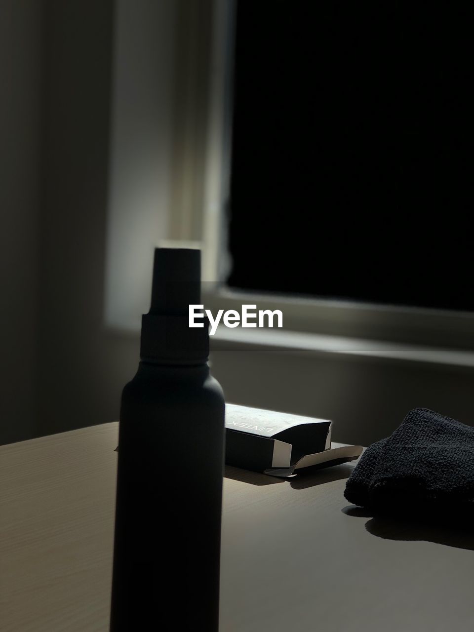 CLOSE-UP OF WINDOW ON TABLE AGAINST WALL