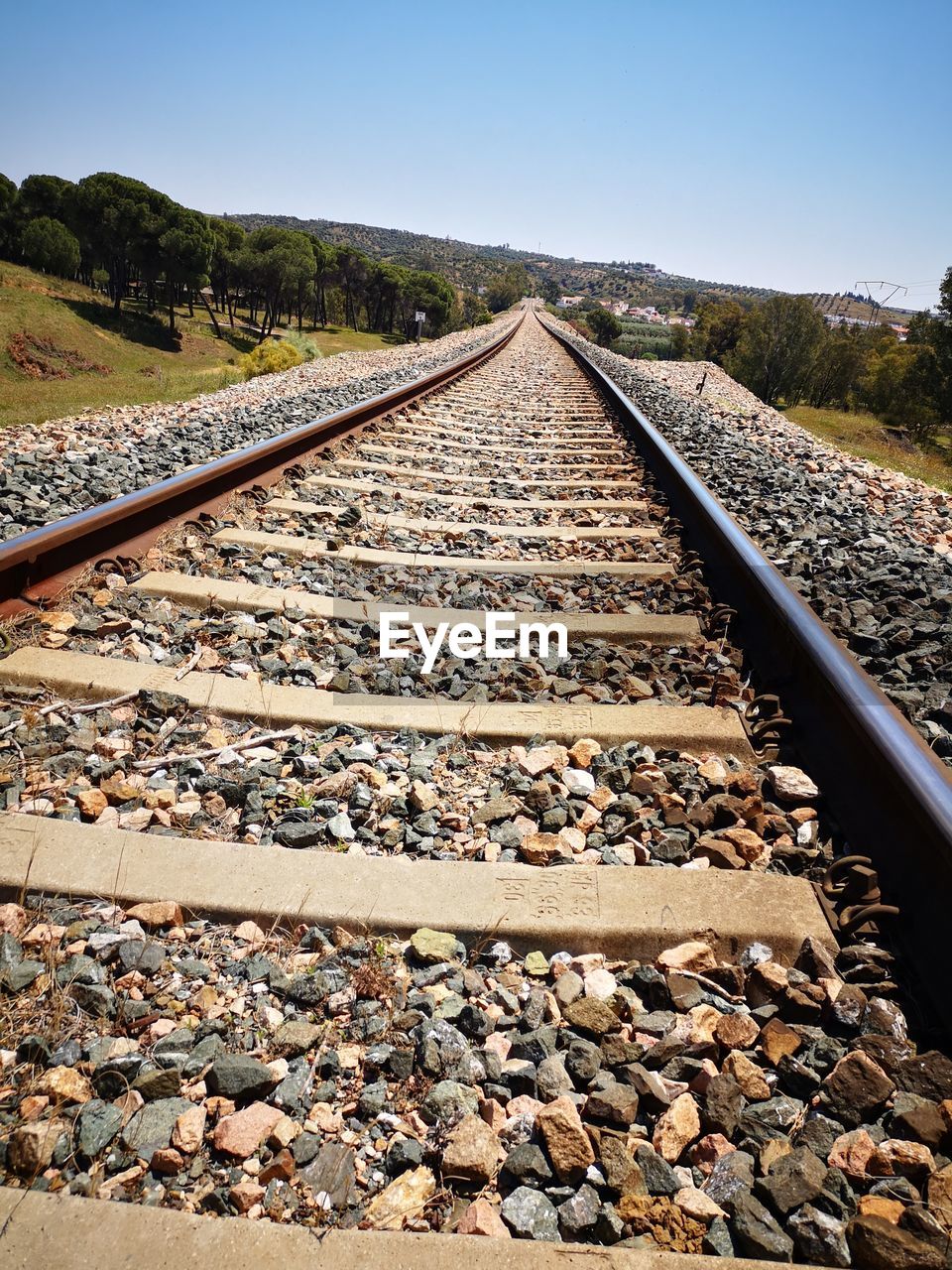 HIGH ANGLE VIEW OF RAILROAD TRACKS AGAINST CLEAR SKY