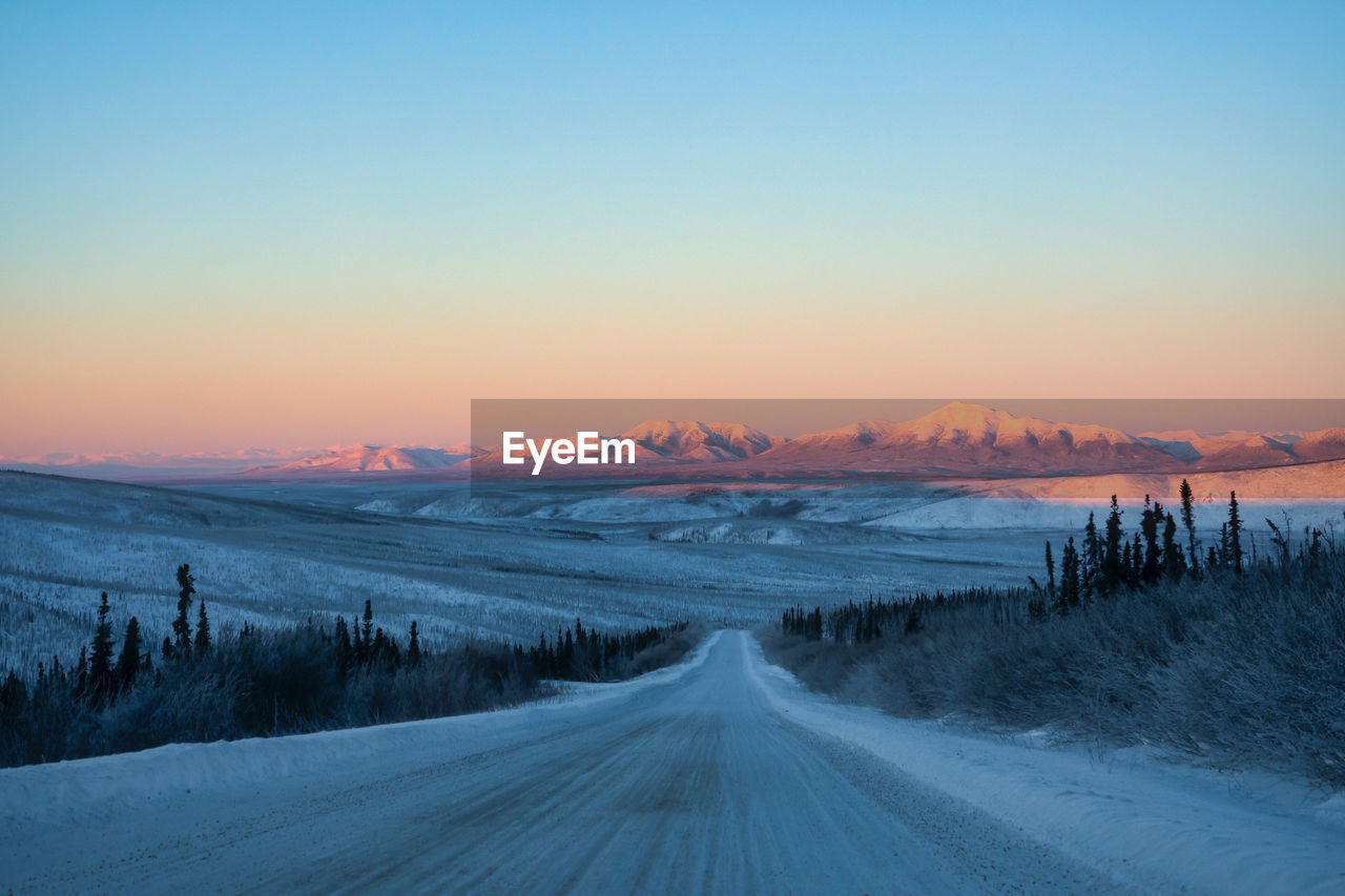 SCENIC VIEW OF SNOW COVERED LAND