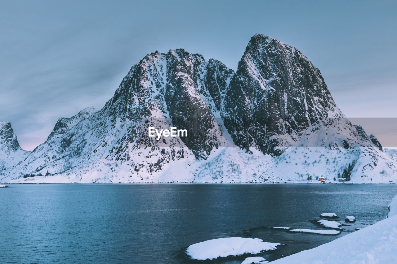 Frozen lake against mountain during winter