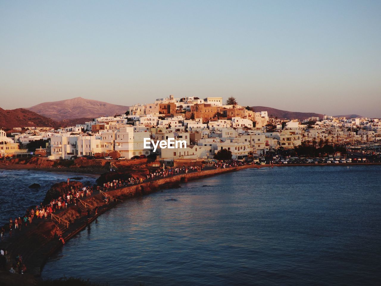 Town by sea against clear sky