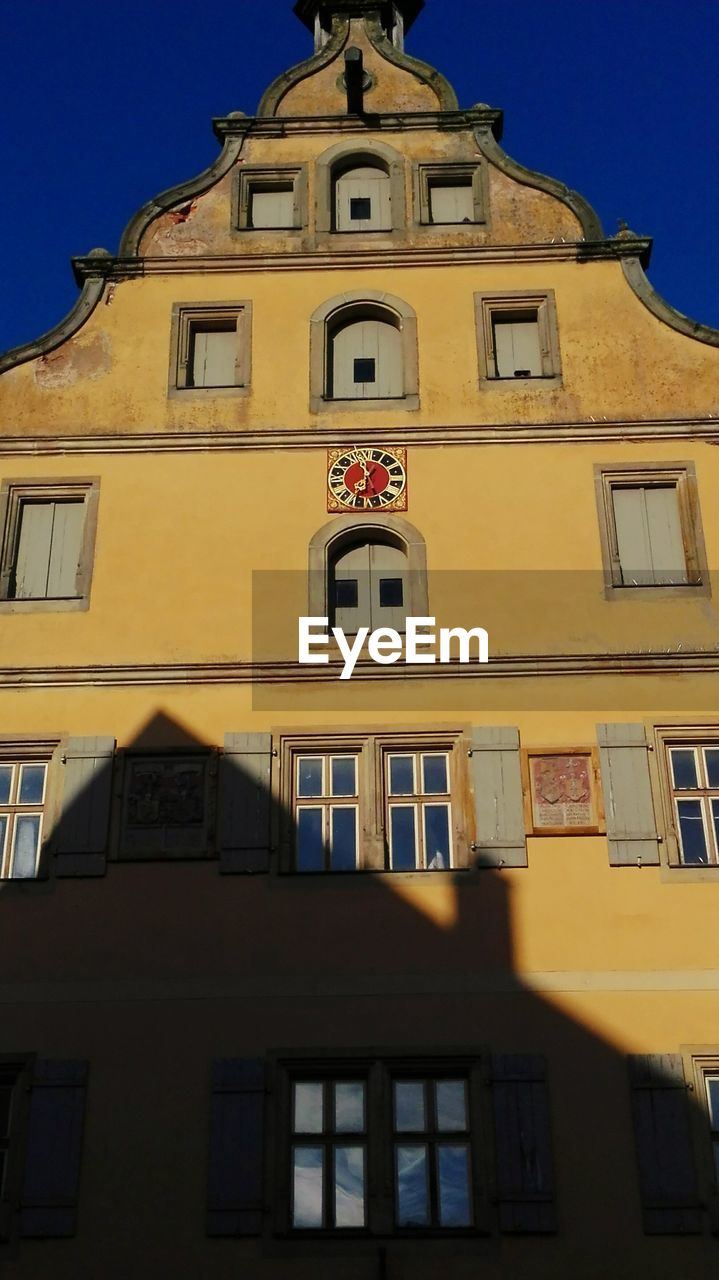 LOW ANGLE VIEW OF YELLOW BUILDING