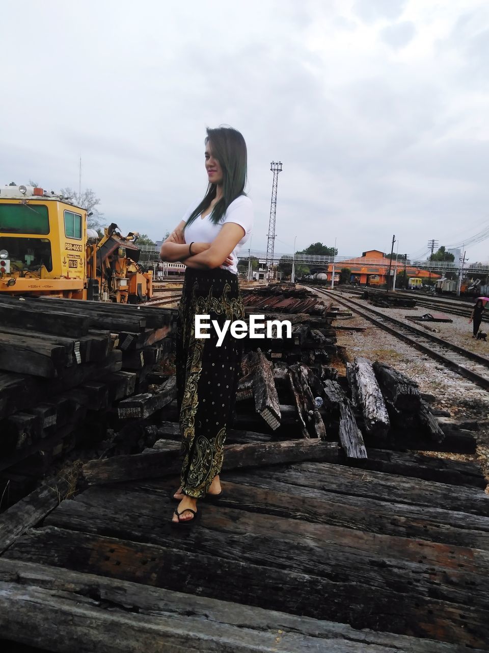 Woman standing on railroad track against sky