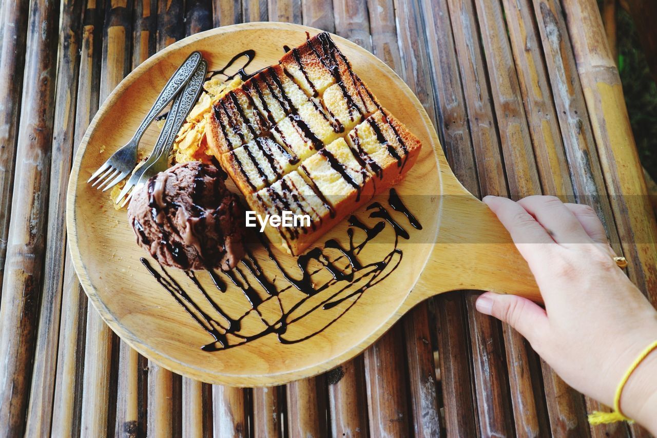 High angle view of hand holding cake