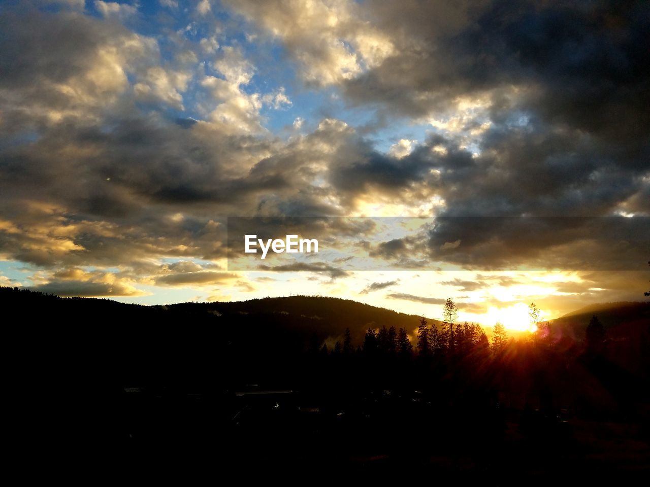 SILHOUETTE OF LANDSCAPE AGAINST SUNSET SKY