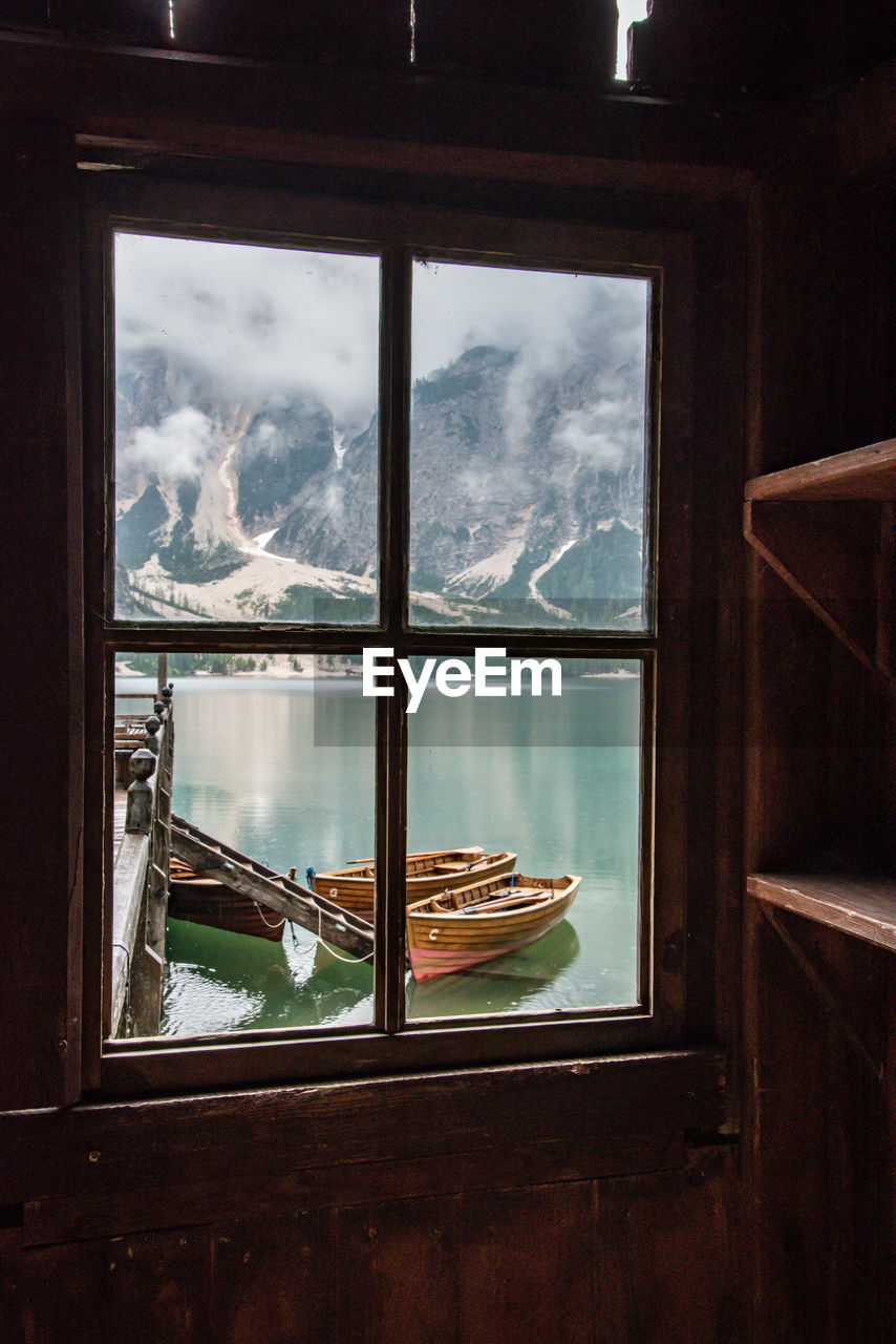 SCENIC VIEW OF MOUNTAIN SEEN THROUGH WINDOW