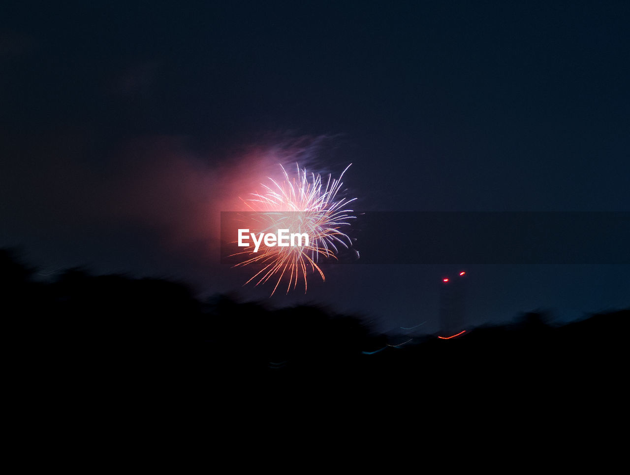 LOW ANGLE VIEW OF FIREWORKS IN SKY AT NIGHT