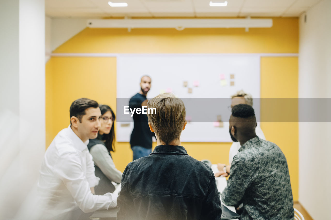 Business people brainstorming during meeting in board room at office