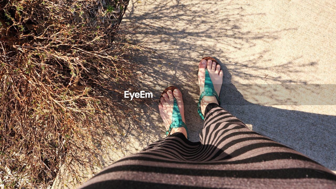 Low section of a woman standing on ground