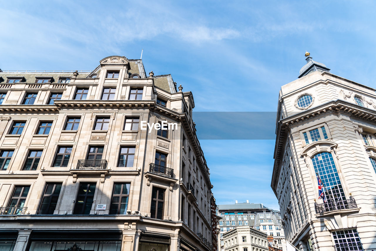 Low angle view of old buildings in regent street in london against blue sky