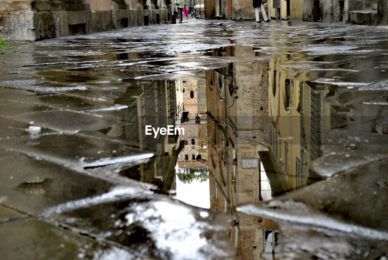 Reflection of buildings in puddle