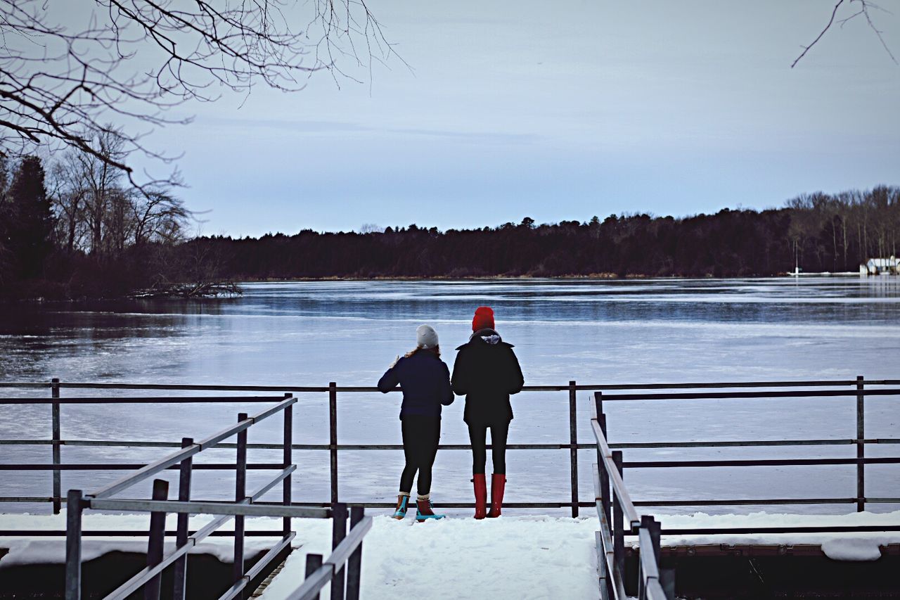 FRIENDS STANDING ON RIVERBANK