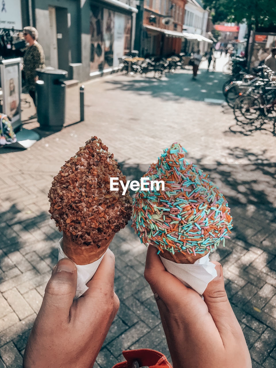 MIDSECTION OF PERSON HOLDING ICE CREAM