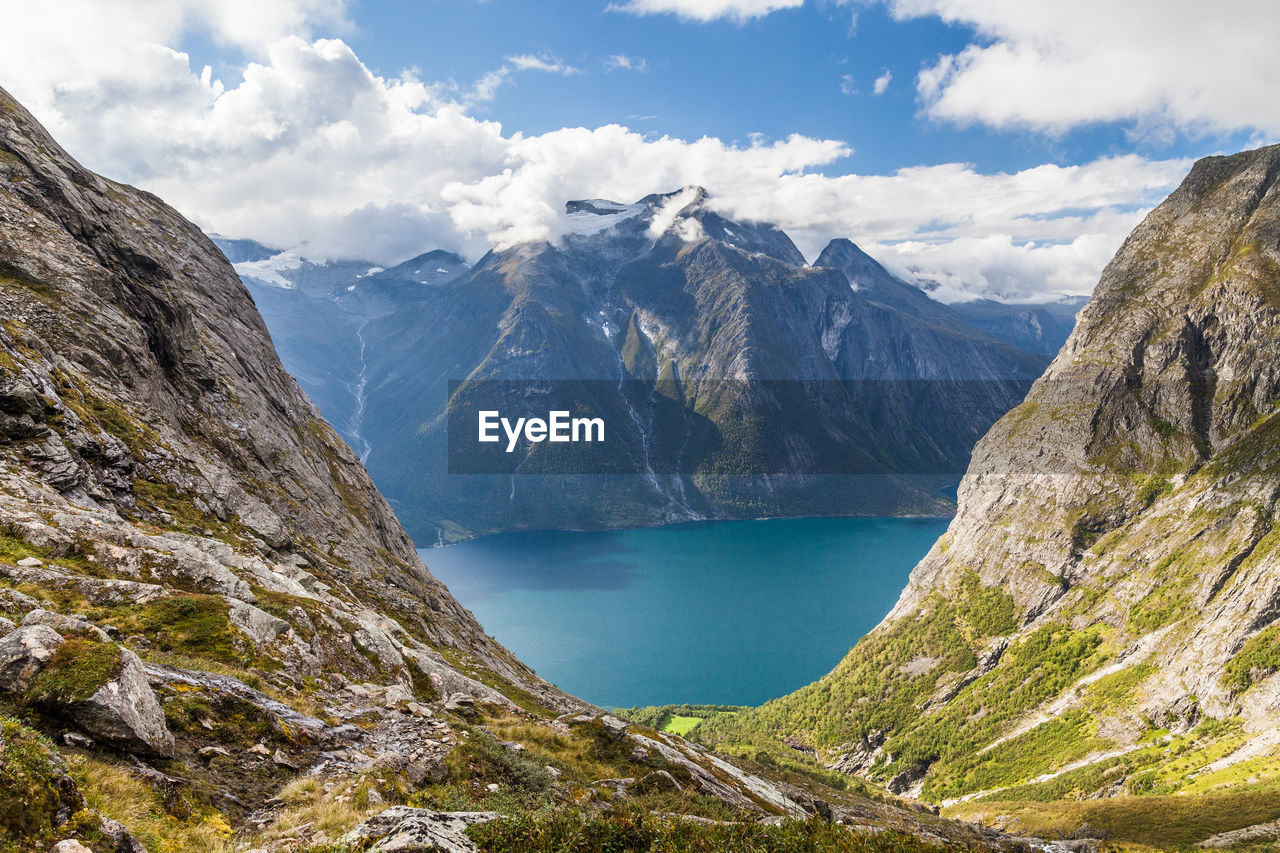 Idyllic shot of lake and mountains against sky