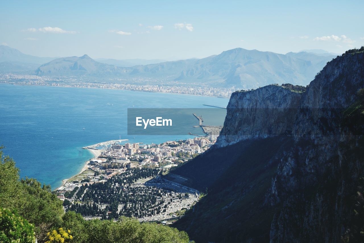 Panoramic view of sea and mountains against sky