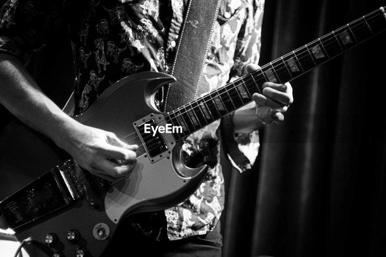 cropped image of man playing guitar