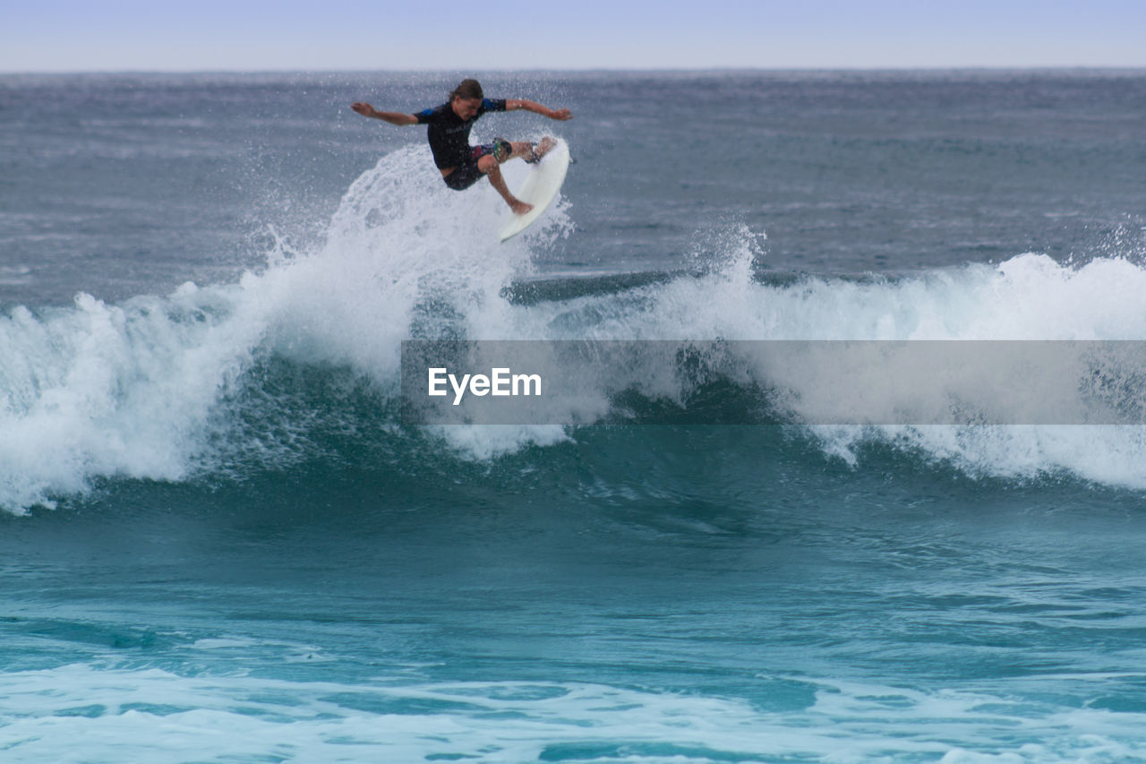 PEOPLE SURFING ON WATER