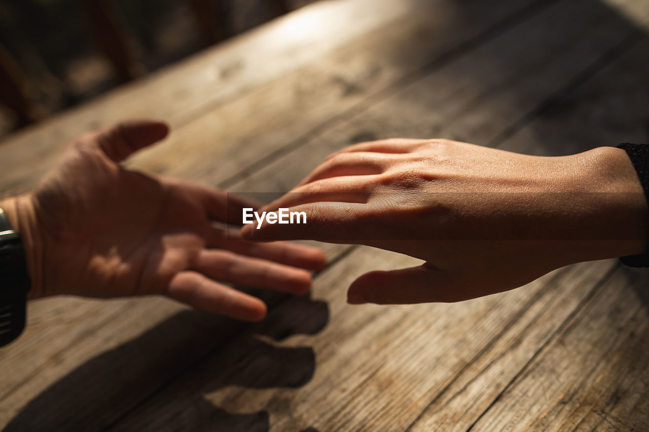 Close-up of hands on table