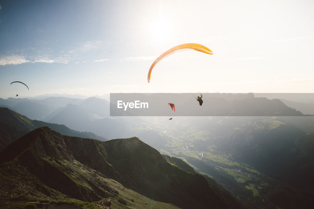 Low angle view of person paragliding against sky