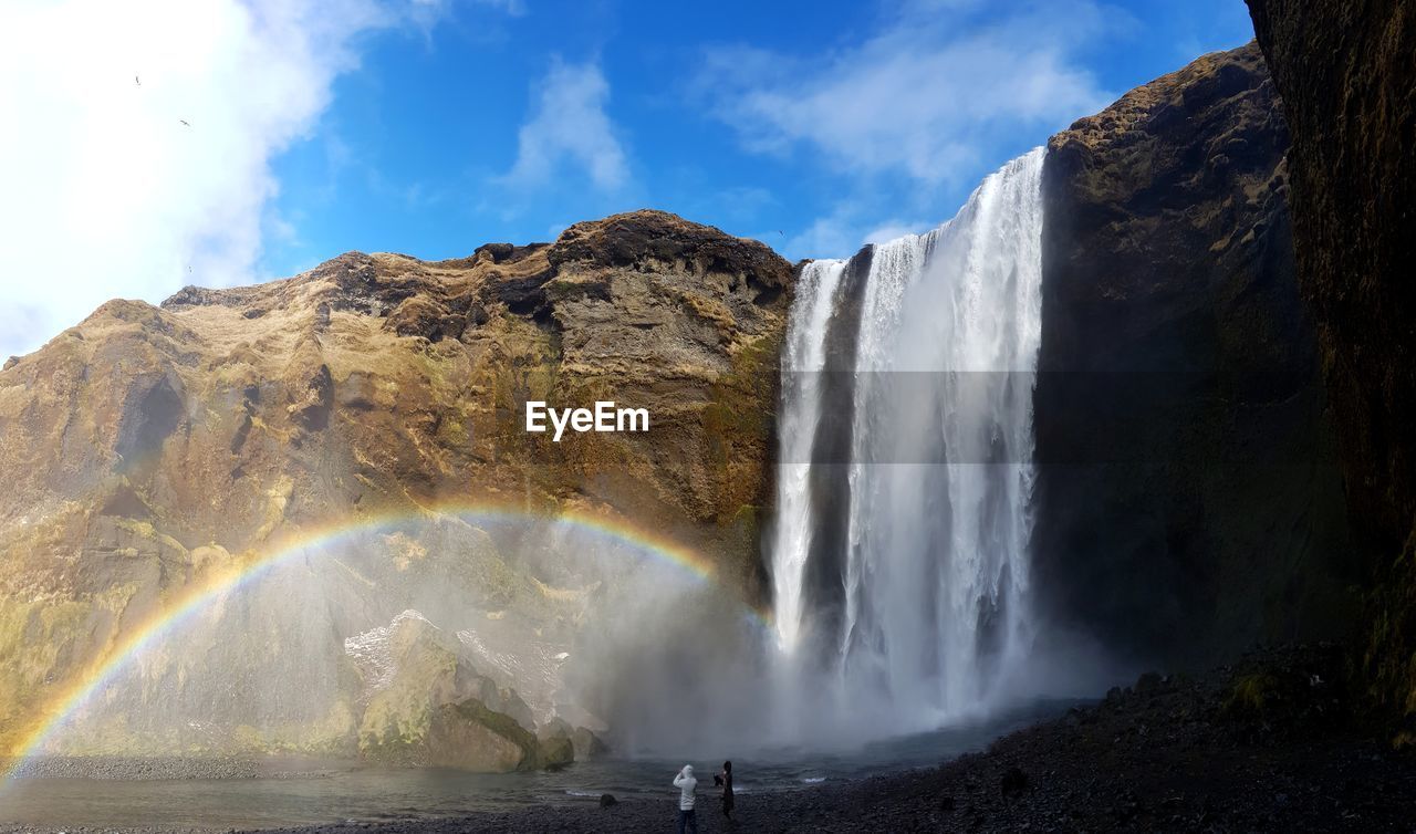 Scenic view of waterfall against sky