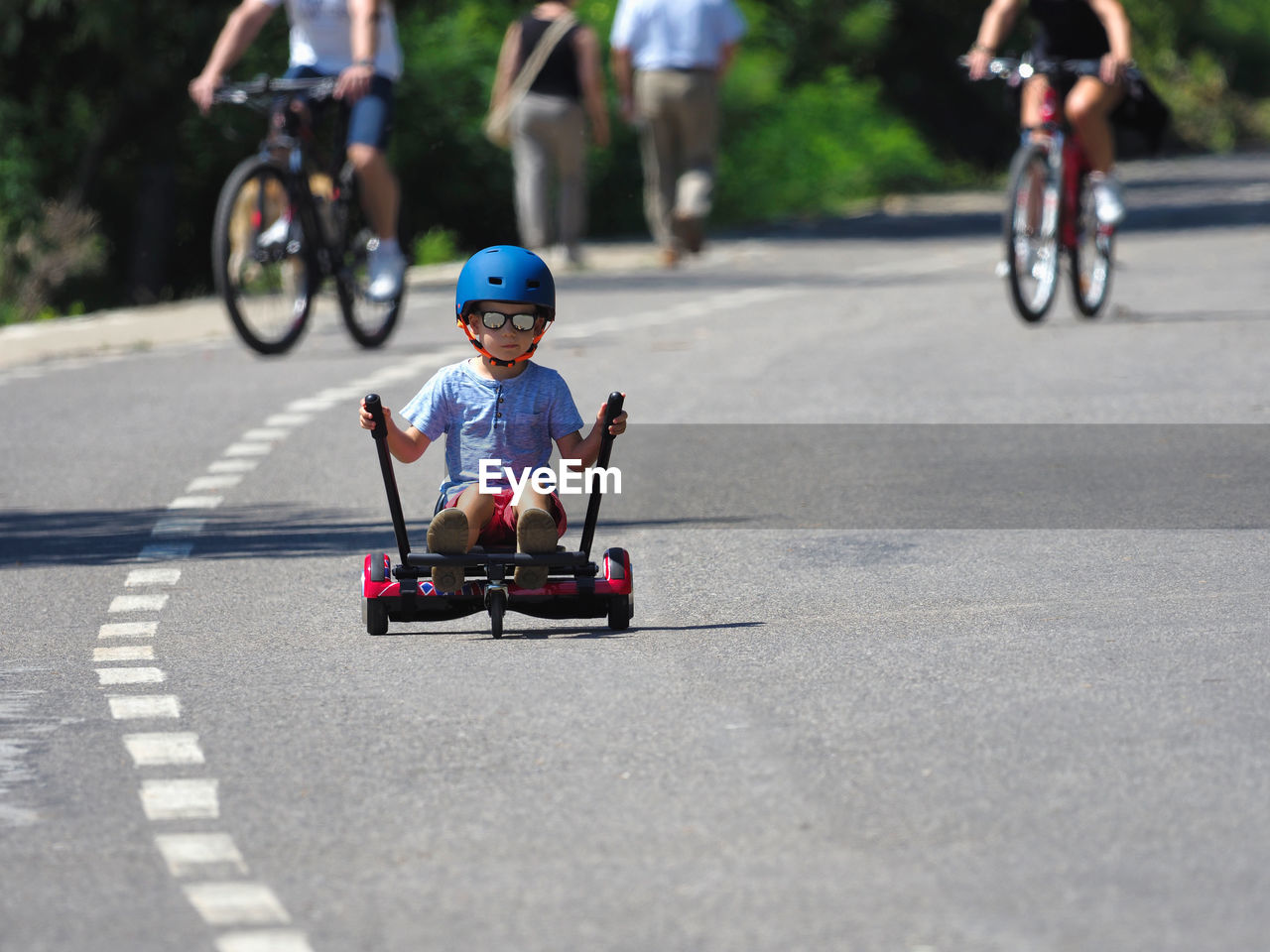 Full length of boy riding segway on road