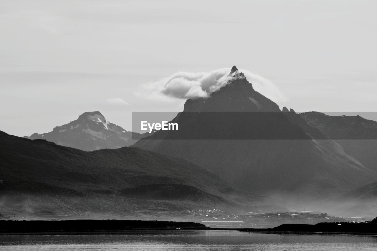 Scenic view of sea and mountains against sky