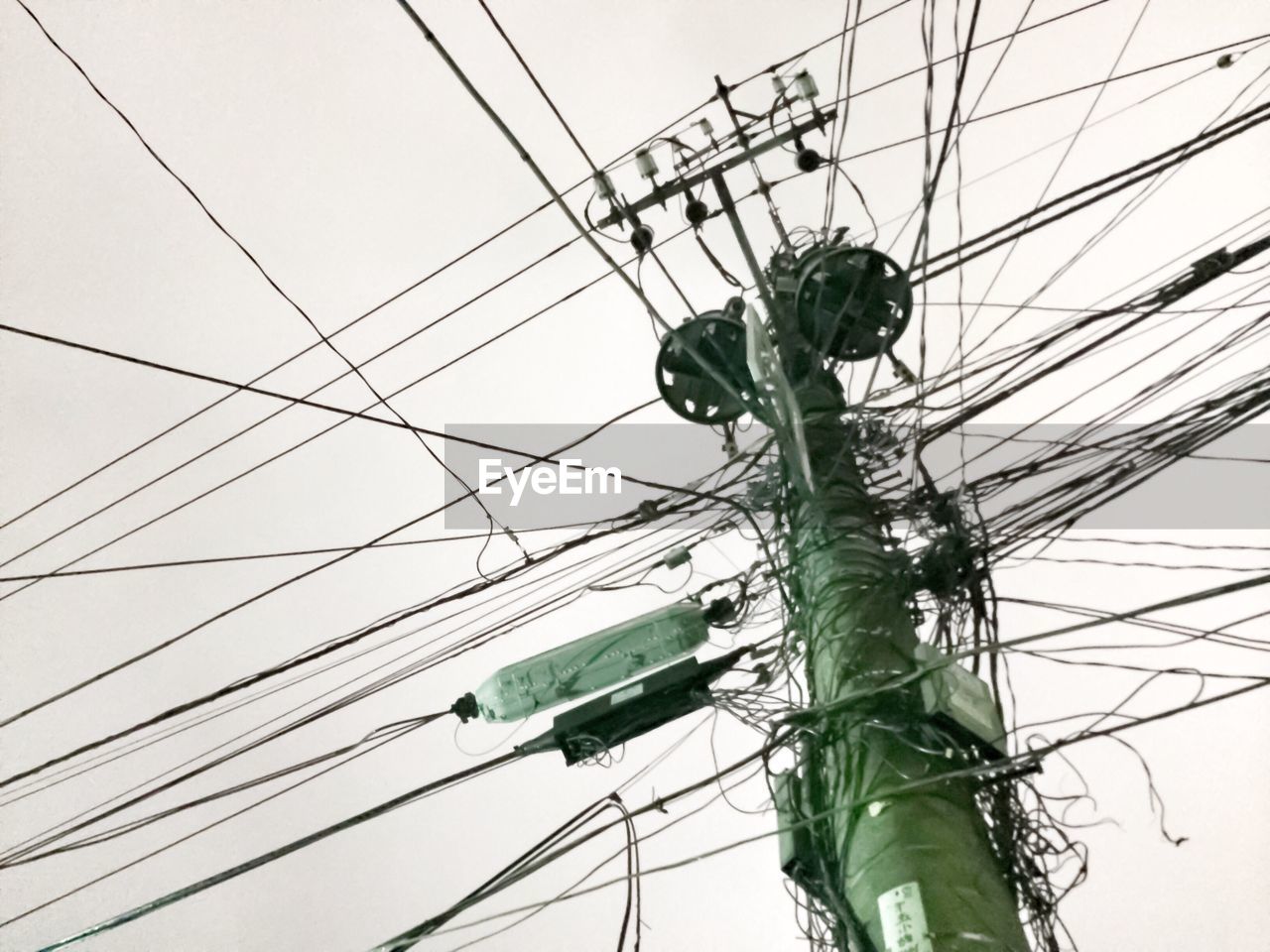 LOW ANGLE VIEW OF POWER LINES AGAINST CLEAR SKY