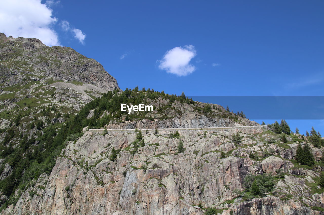 LOW ANGLE VIEW OF ROCK FORMATION AGAINST SKY