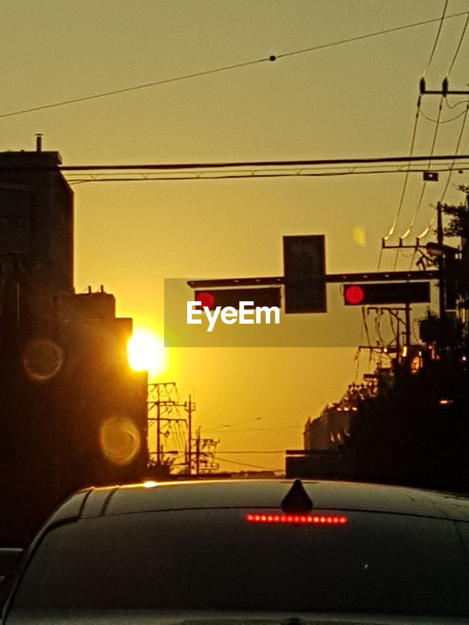 CAR IN ILLUMINATED CITY AGAINST CLEAR SKY