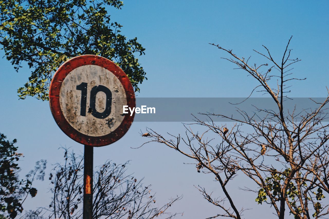 LOW ANGLE VIEW OF SIGN AGAINST CLEAR SKY