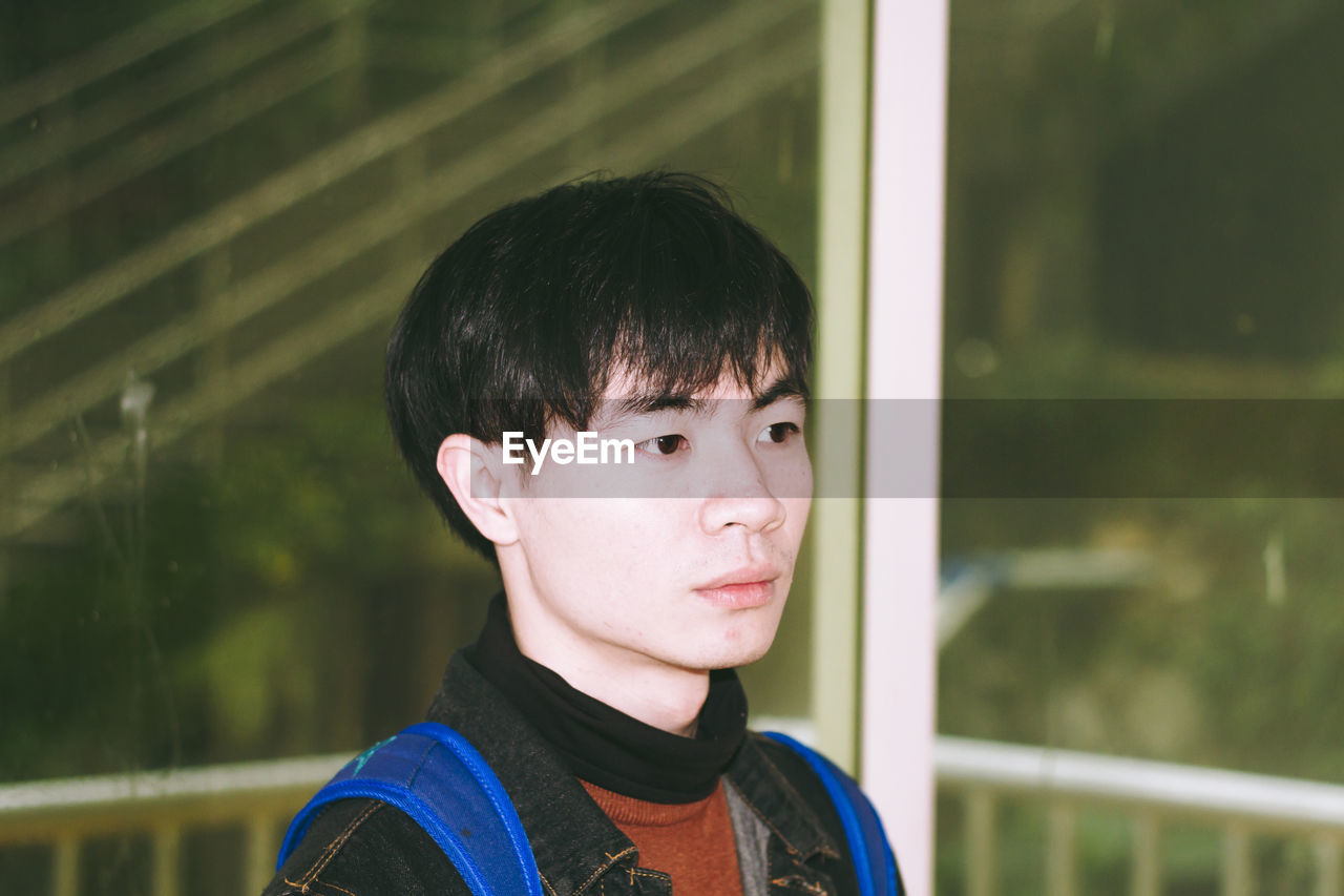 Close-up of thoughtful young man looking away