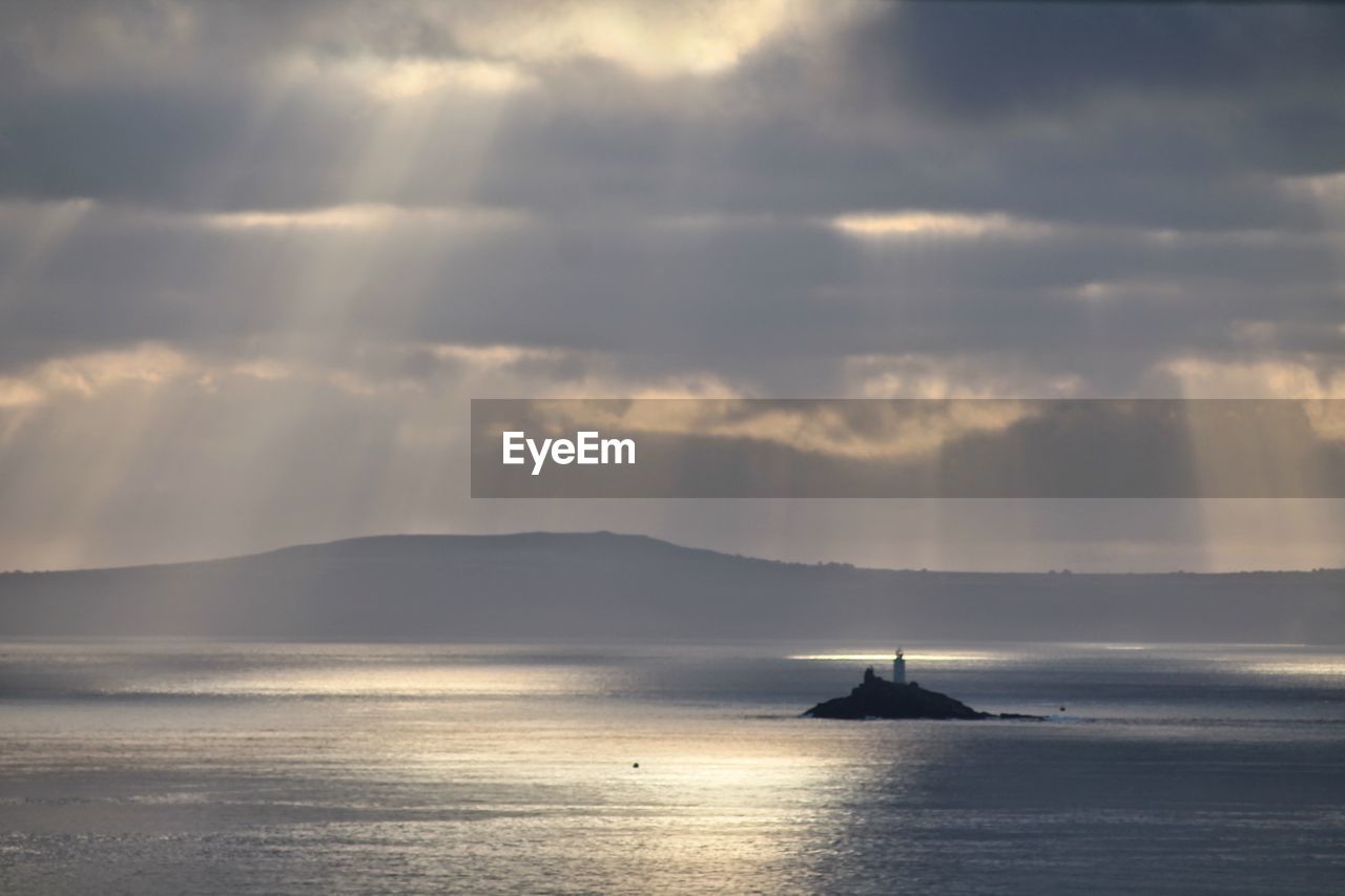 BOATS SAILING IN SEA AGAINST CLOUDY SKY