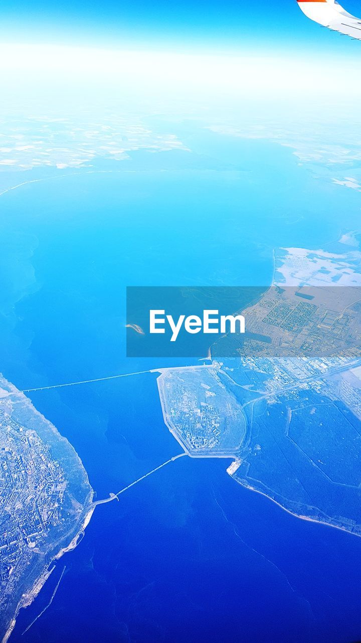 AERIAL VIEW OF SEA SEEN THROUGH AIRPLANE WING