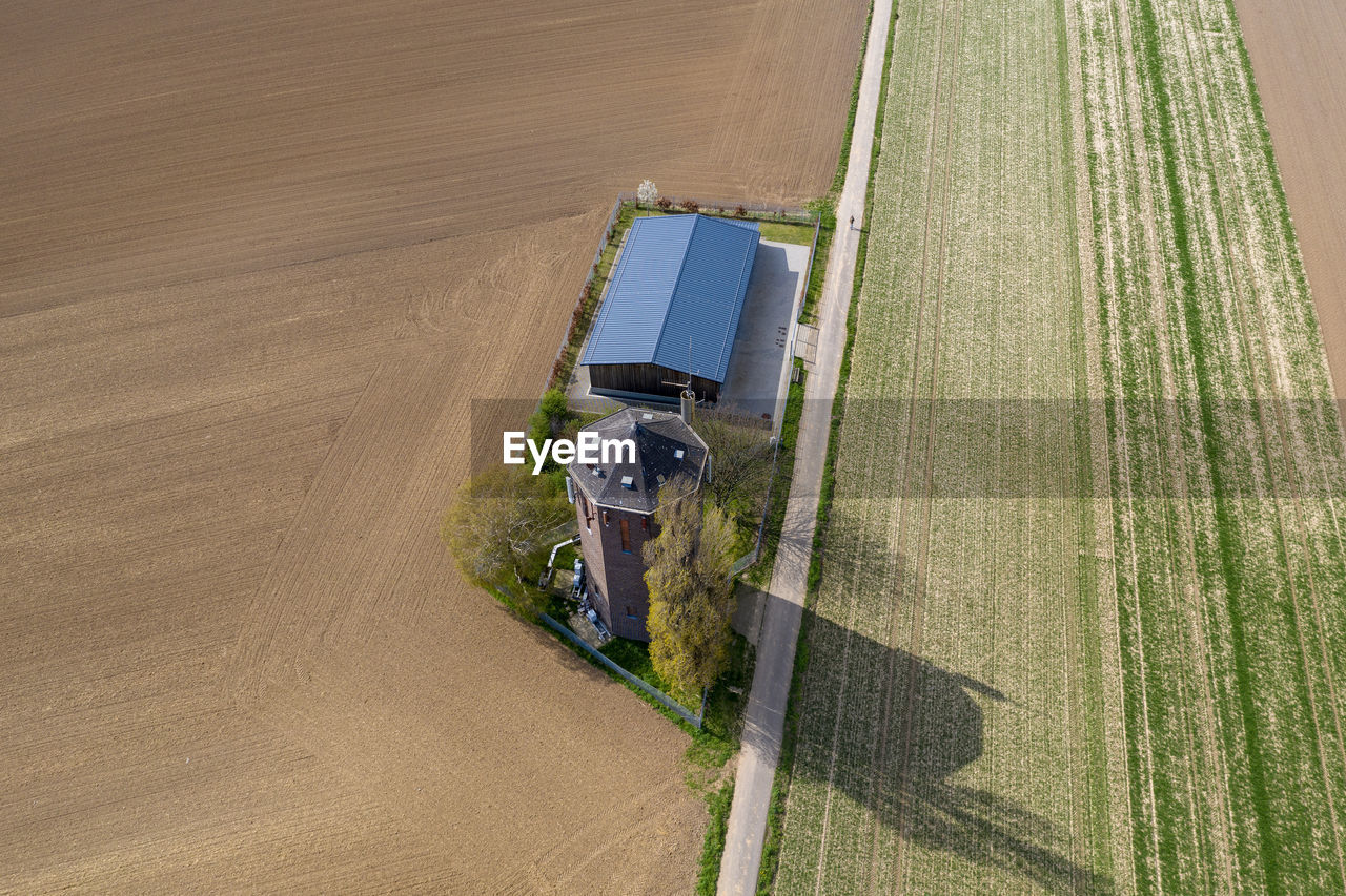 HIGH ANGLE VIEW OF ROAD AMIDST AGRICULTURAL LAND