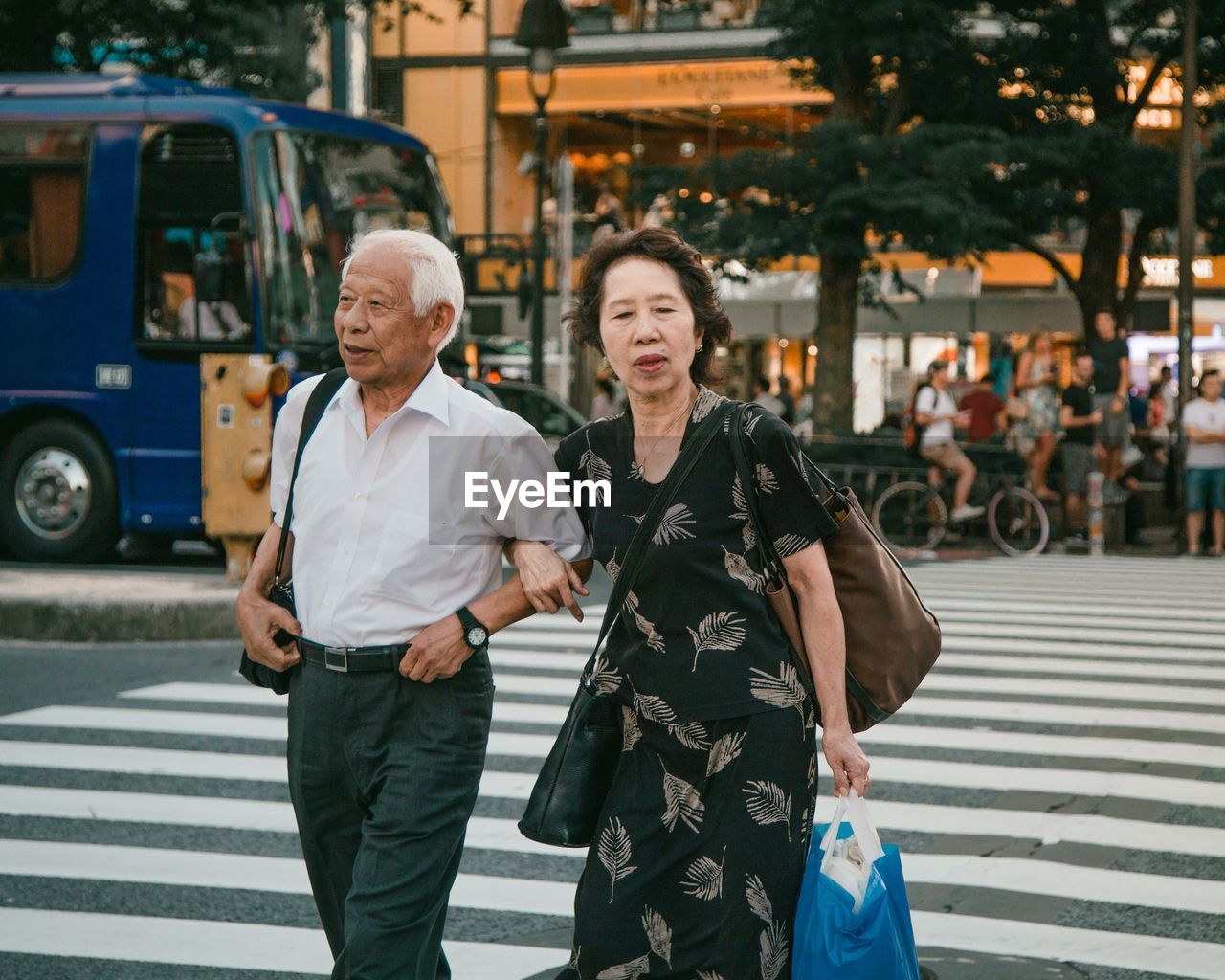 FULL LENGTH OF A SMILING COUPLE IN CITY