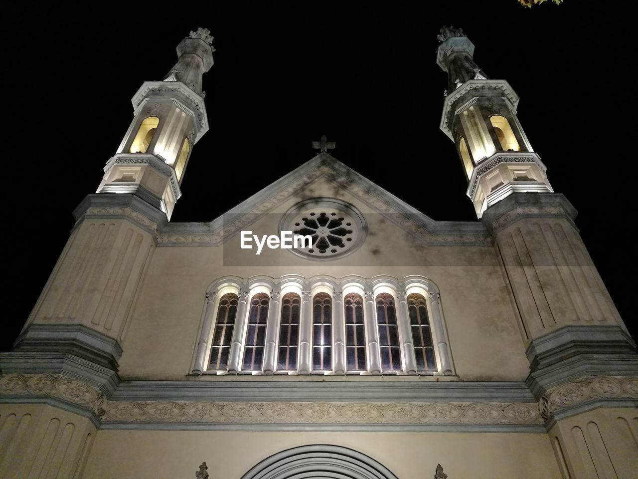 LOW ANGLE VIEW OF ILLUMINATED CATHEDRAL