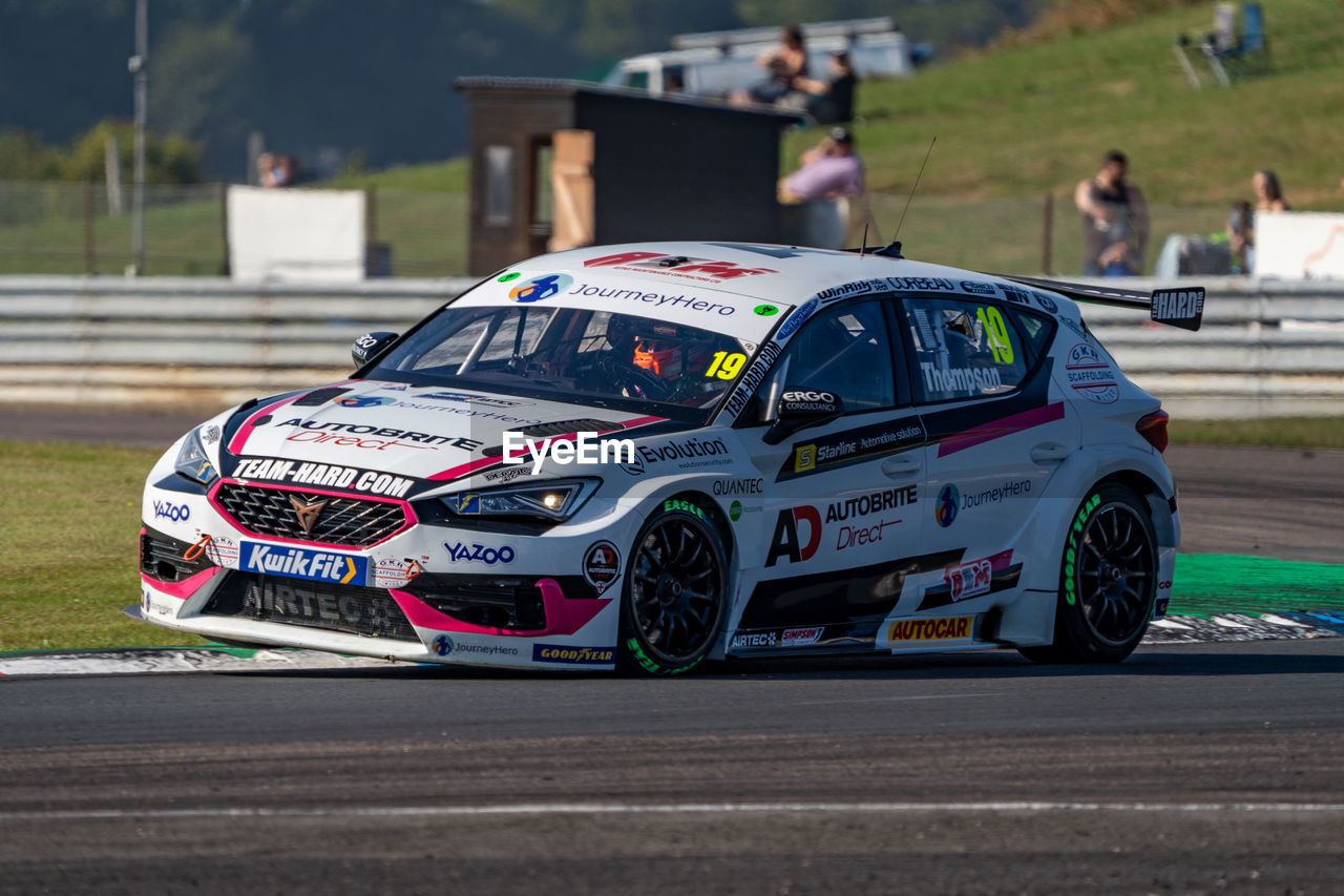 car, rallycross, transportation, mode of transportation, automobile, auto racing, touring car, motor vehicle, racing, world rally car, motorsport, vehicle, sports, race track, race car, rallying, race, road, land vehicle, sports car, driving, day, family car, architecture, outdoors, track and field event, luxury vehicle, street