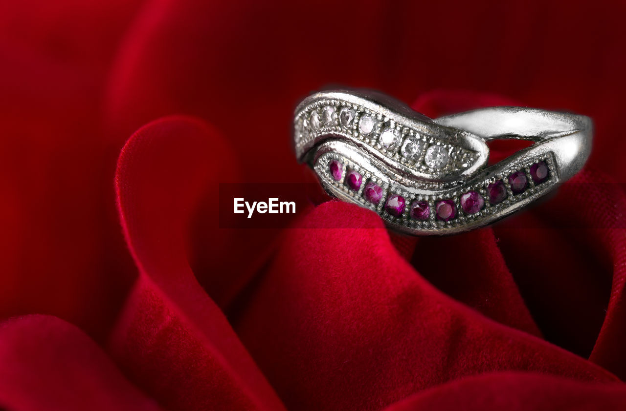 Silver wedding ring placed on rose.wedding rings, special gifts for couples.